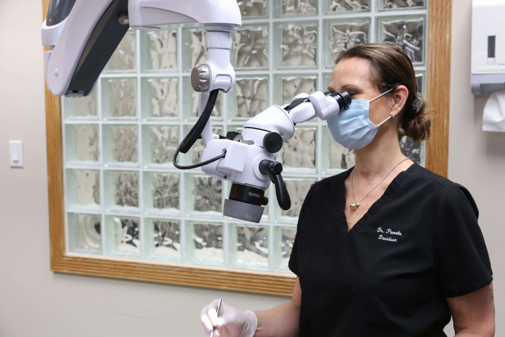 Dentist using dental microscope for precise treatment at Dentists on Dunbar in Vancouver